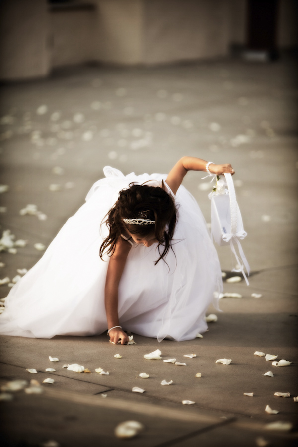 young girl picking up flower petals - wedding photo by top Orange County, California wedding photographers D. Park Photography